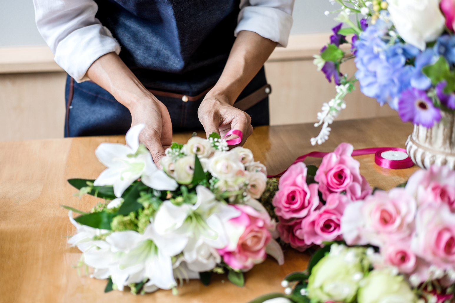 A florist arranging flowers for orders